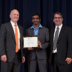 Doctor Potteiger and Doctor Smart posing for a photo with an award recipient in a grey suit